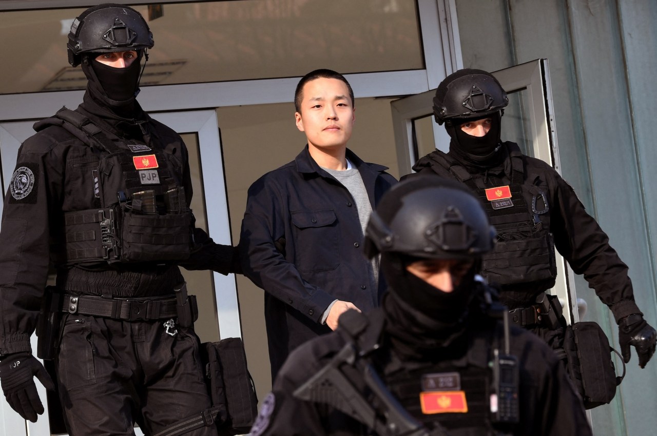 Montenegrin police officers of the PJP (Special Police Unit) escort South Korean cryptocurrency entrepreneur Do Kwon (C) at the exit of a court in Podgorica, Montenegro